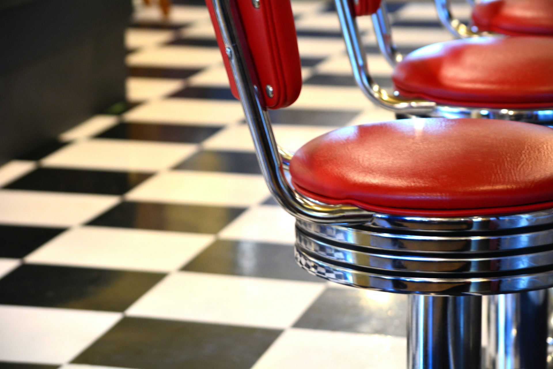American diner style seating with checkerboard pattern flooring. 