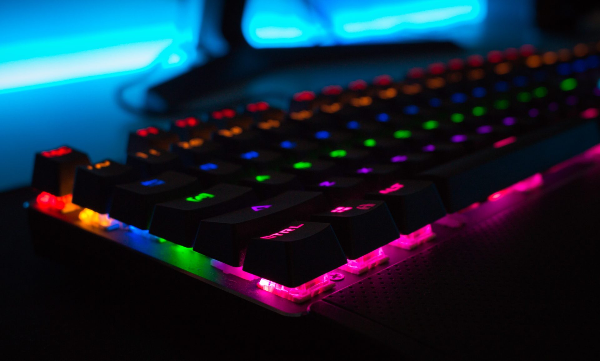A keyboard with LED lights in rainbow colours. 